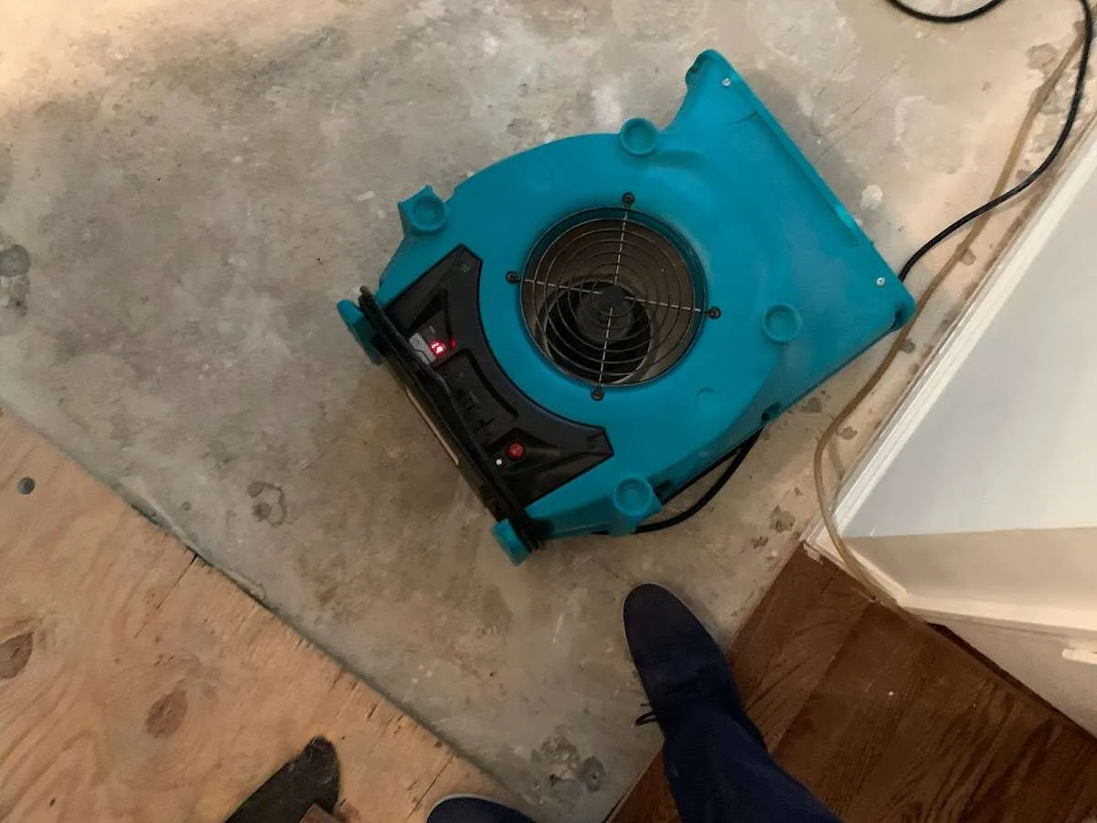 Air mover drying subfloor during Commercial Water Damage Restoration in Ballwin